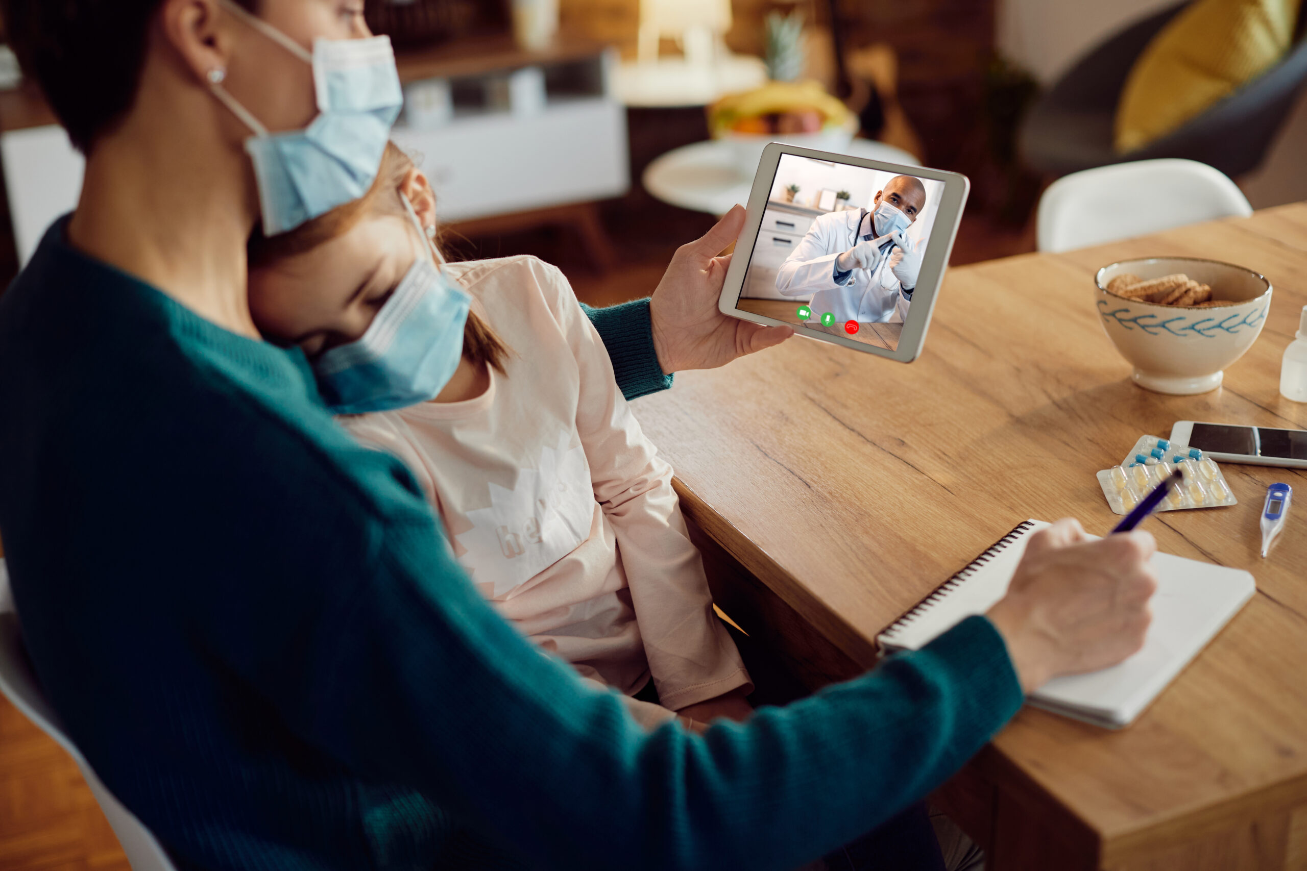 Close-up of black pediatrician advising mother during video call Smart, Convenient, and Connected: Telehealth Made for You